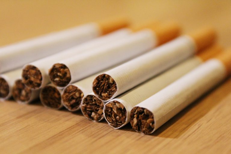 a group of cigarettes sitting on top of a wooden table